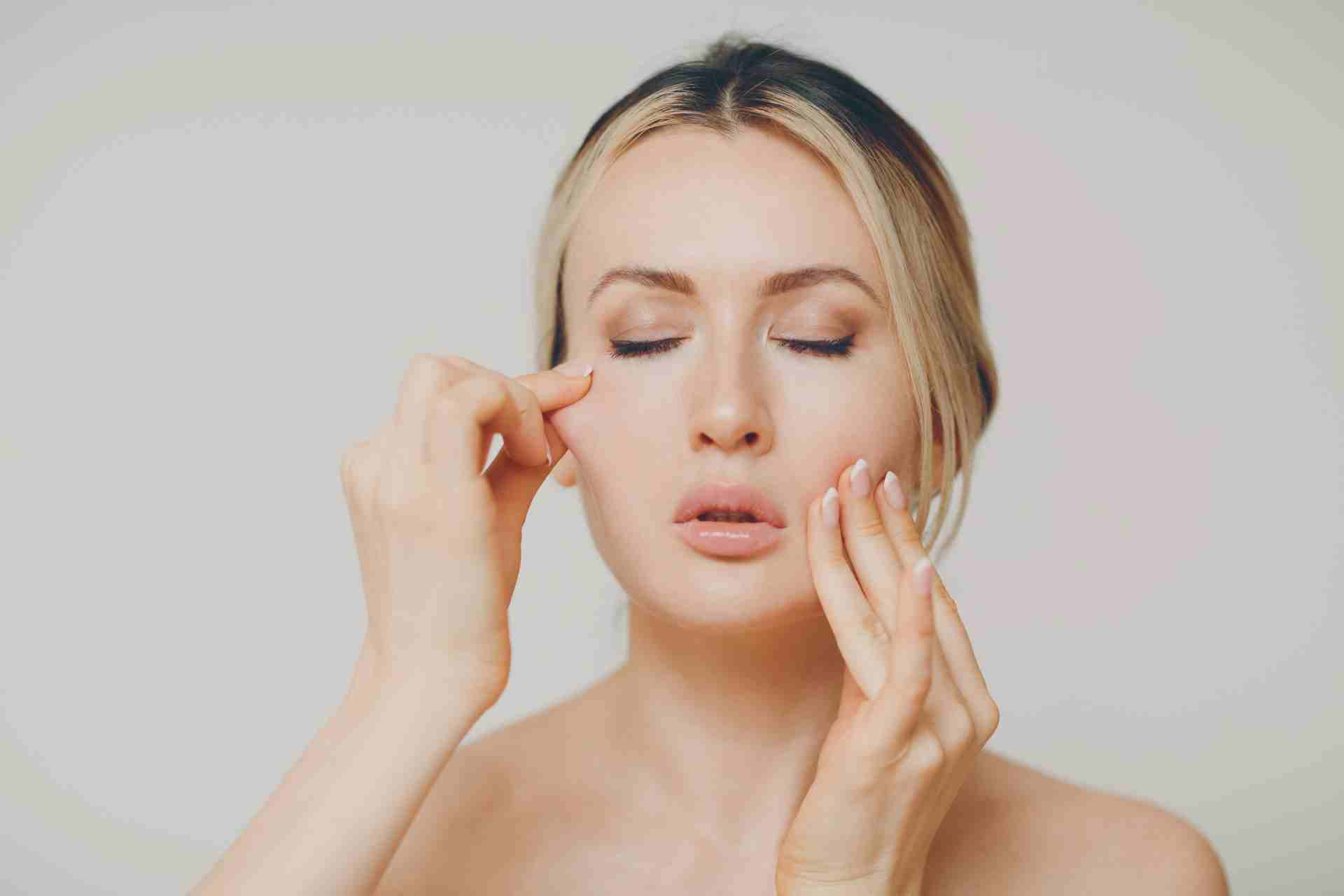 Woman doing facial massage.