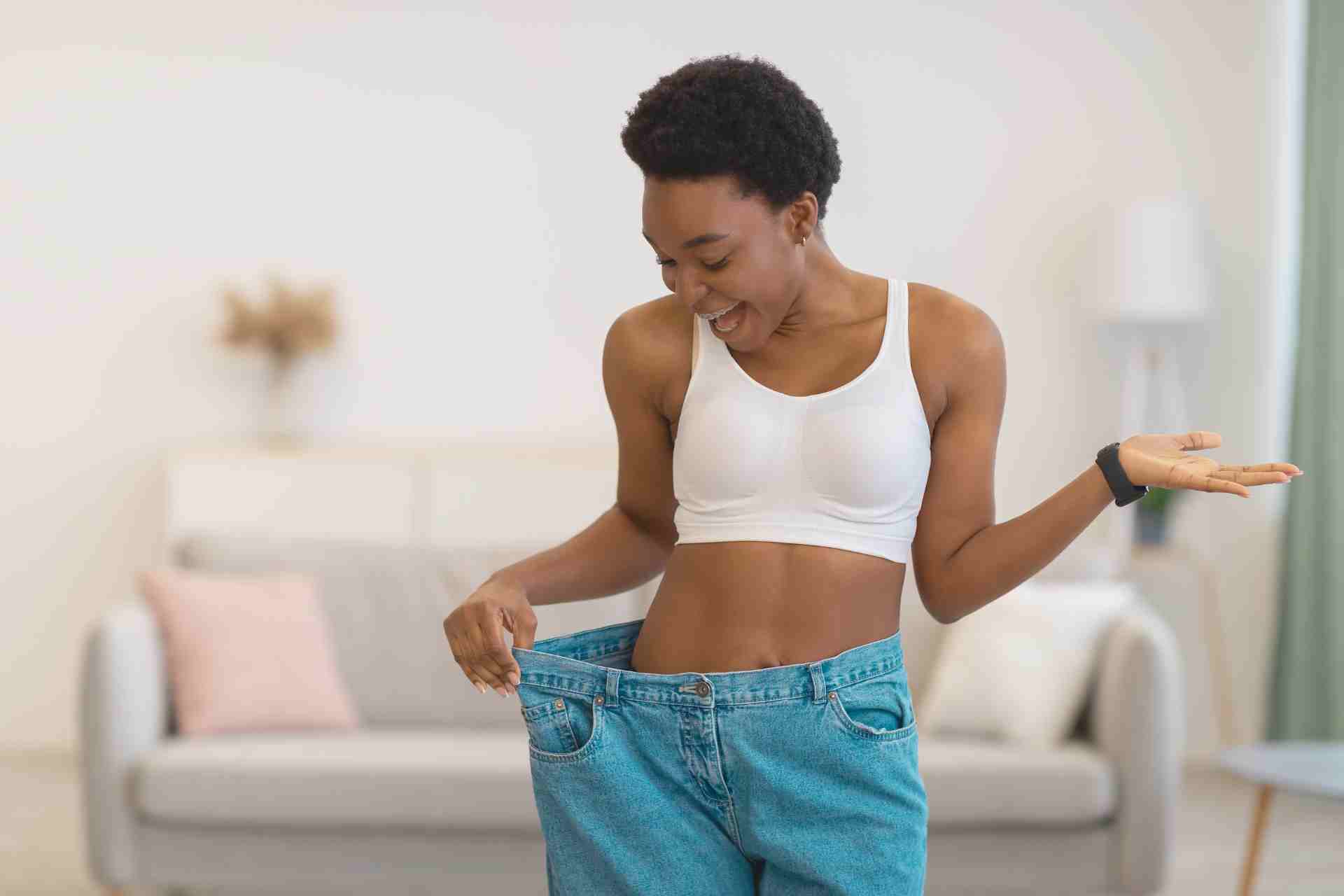Excited Slim African Woman Wearing Oversized Pants