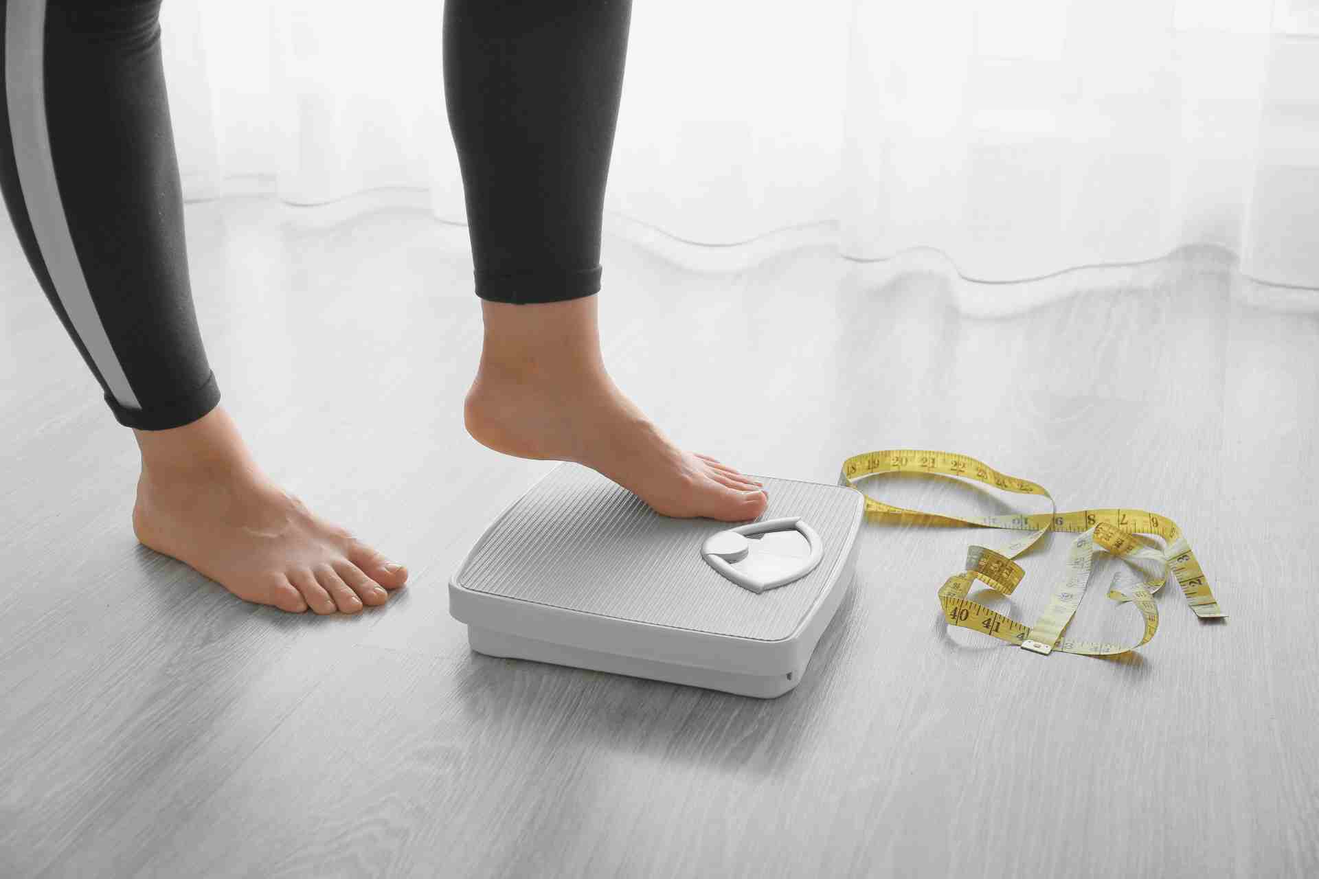 Woman with scales at home.