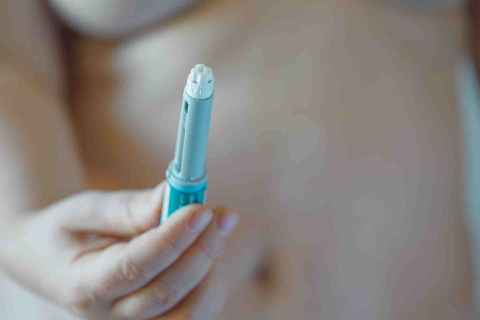 Semaglutide injection pen or cartridge pen for diabetics and weight loss in female hand.